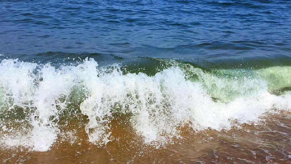 Seagreen waves hitting beach